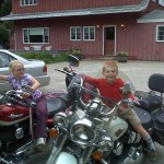 Dick Young's grandkids sitting on his motorcycles.