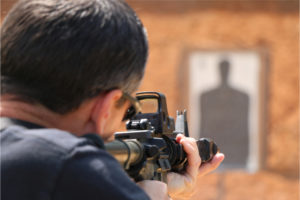Police firearms training with AR-15 at shooting range.
